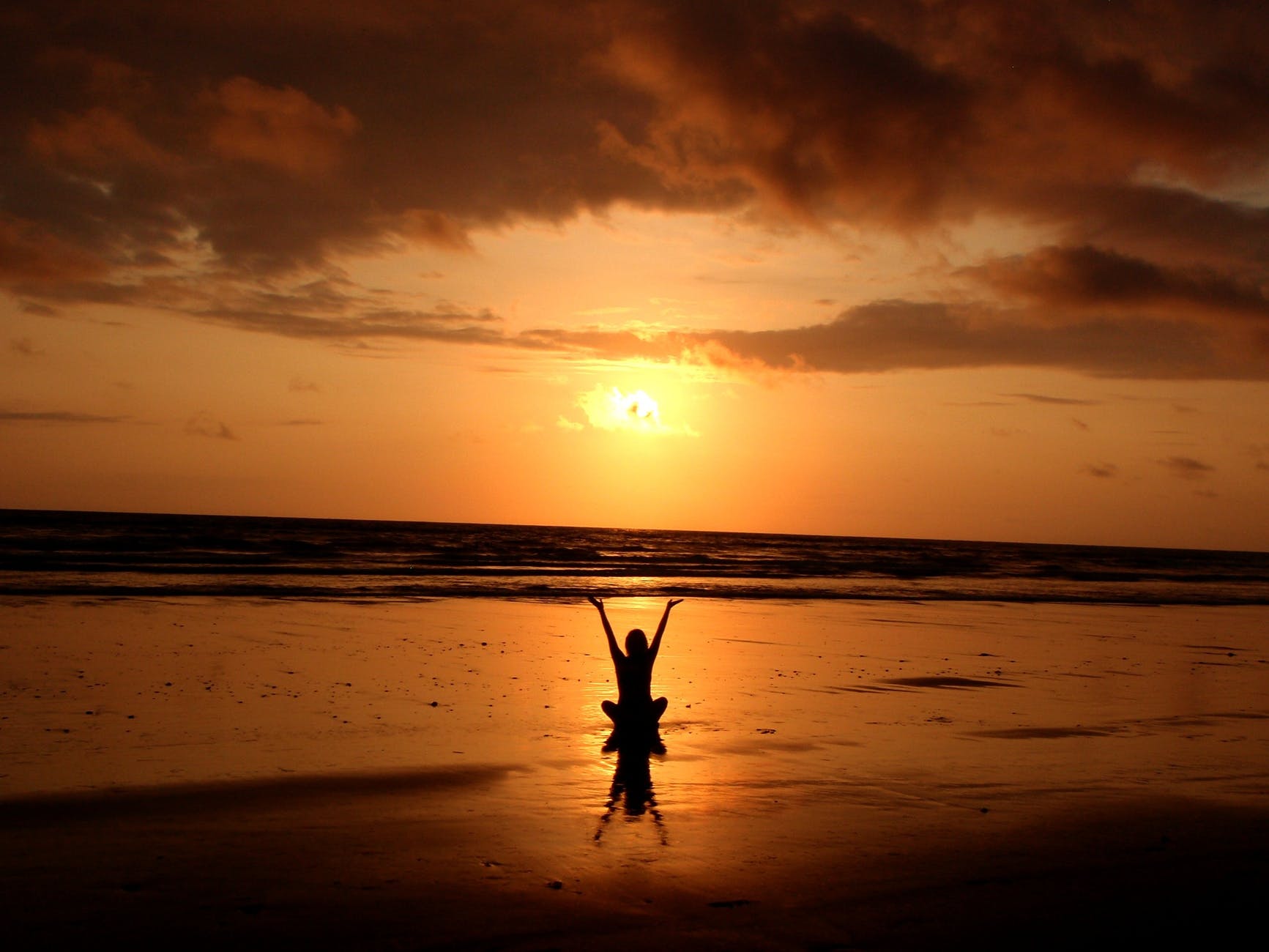 yoga sitting on sunset beach
