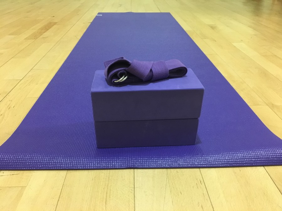 Purple yoga mat, belt and blocks