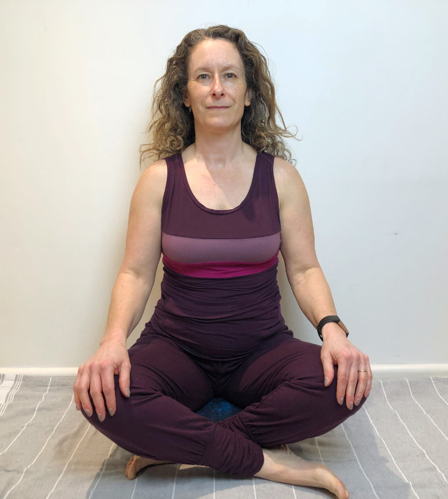 woman sitting in yoga easy pose