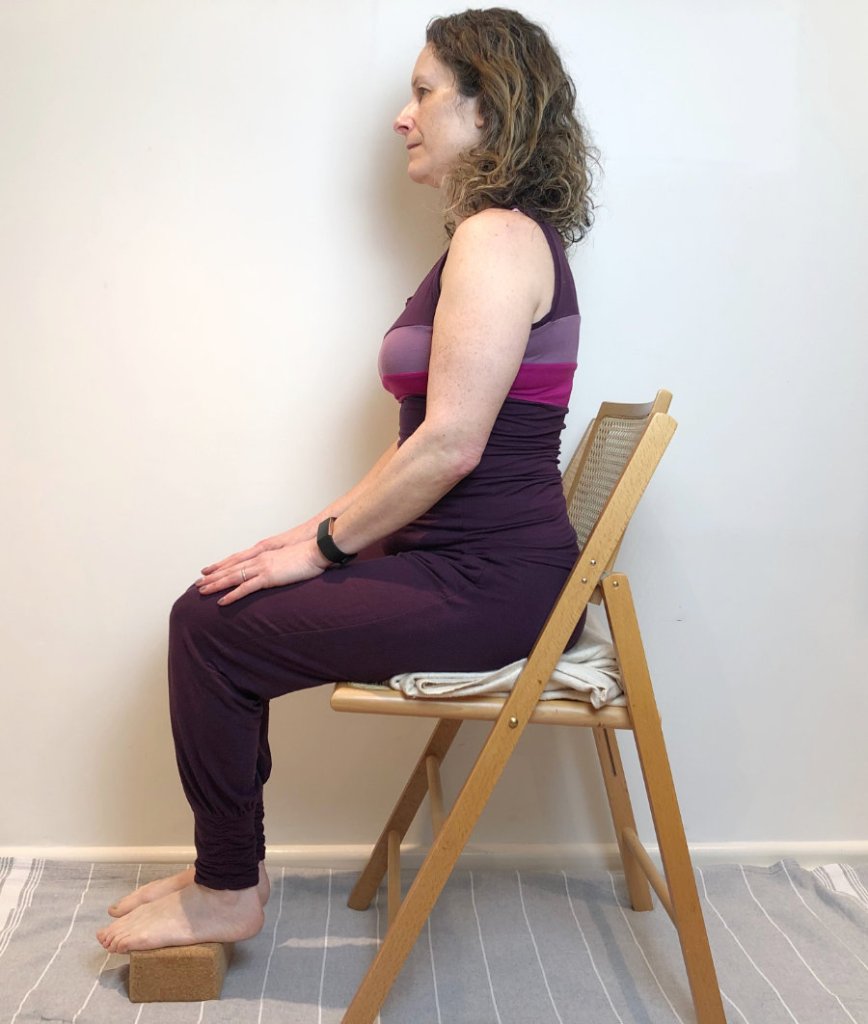 woman sitting on yoga chair